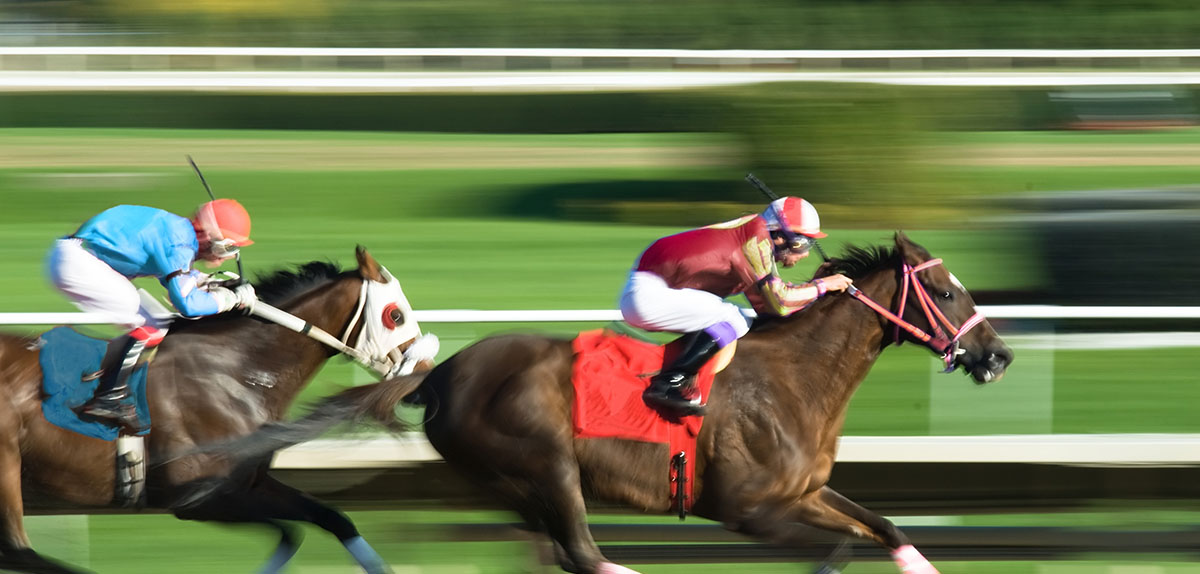 Two racing horses competing with each other, with motion blur to accent speed